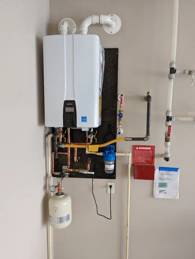 Professional plumber installing copper piping in a Goodland home